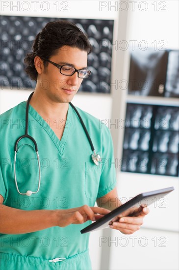 Portrait of male doctor using digital tablet.