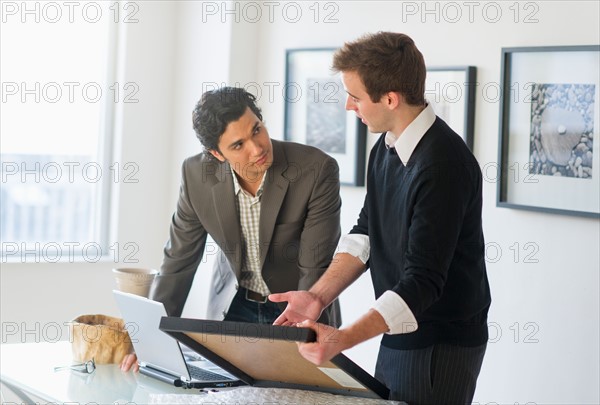 Two men working in art gallery.