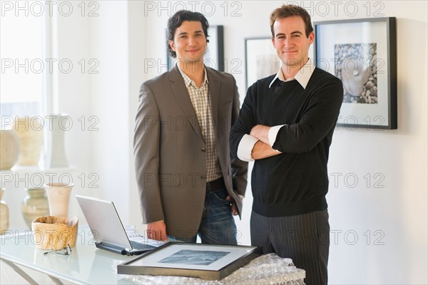 Two men working in art gallery.