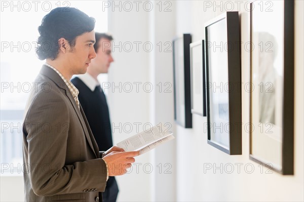 Two men working in art gallery.