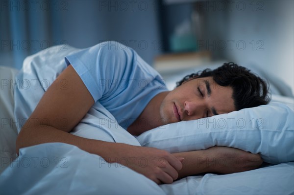 Man sleeping in bed.