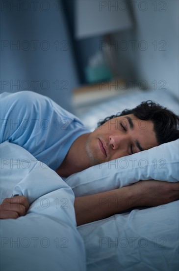 Man sleeping in bed.