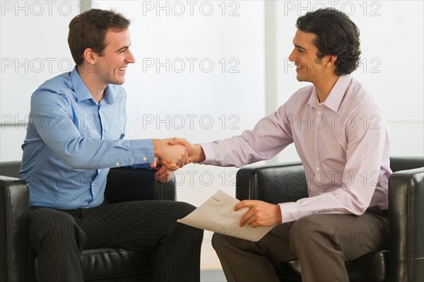 Two businessman shaking hands.