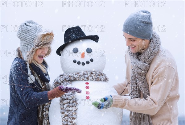 Couple making snowman.