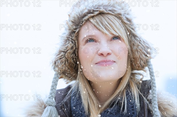 Portrait of woman wearing knit hat smiling.