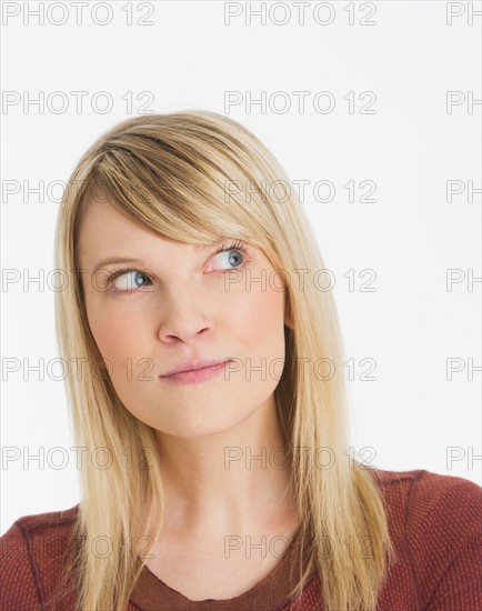 Studio portrait of pensive woman.