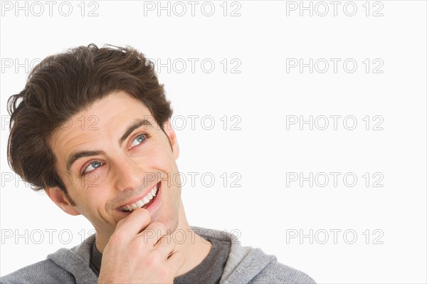 Studio portrait of man smiling.