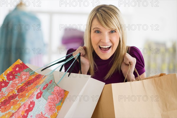 Portrait of woman holding shopping bags.