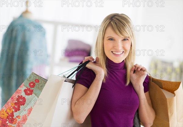 Portrait of woman holding shopping bags.