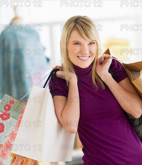 Portrait of woman holding shopping bags.