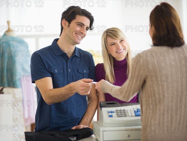 Couple paying with credit card.