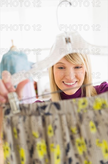 Woman looking at skirt in clothes store.