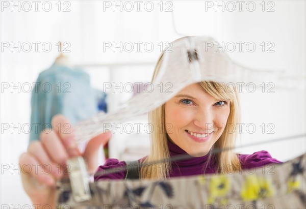 Woman looking at skirt in clothes store.