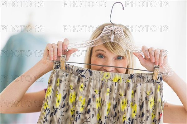 Woman looking at skirt in clothes store.