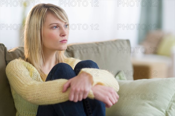 Woman sitting on sofa.