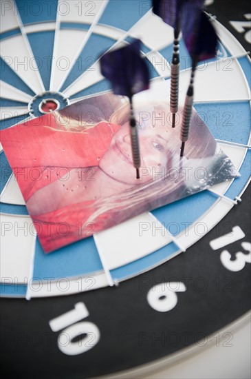 Photograph of woman stuck with darts. Photo : Jamie Grill