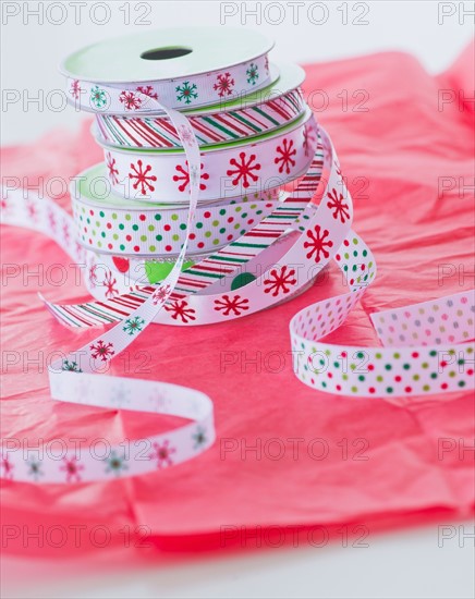 Stack of colorful ribbons on wrapping paper. Photo : Daniel Grill