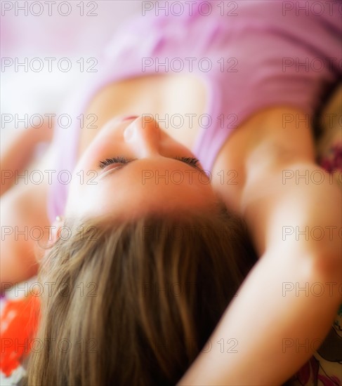 Young attractive woman lying on bed. Photo : Daniel Grill
