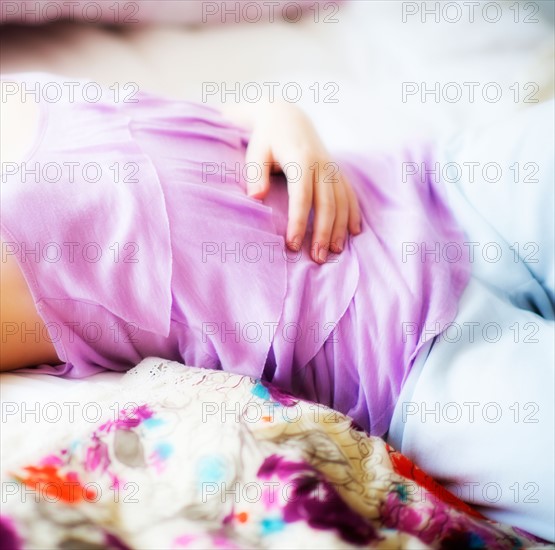 Young attractive woman lying on bed. Photo : Daniel Grill