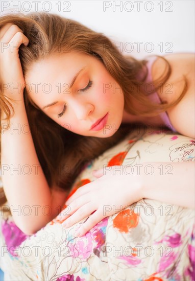 Young attractive woman lying on bed. Photo : Daniel Grill