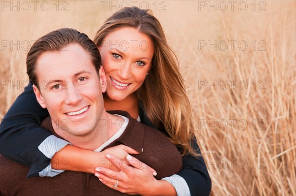 Portrait of happy young couple on wheat field. Photo : Daniel Grill