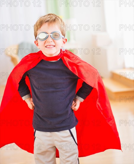 Portrait of boy (6-7) wearing superhero costume. Photo : Daniel Grill