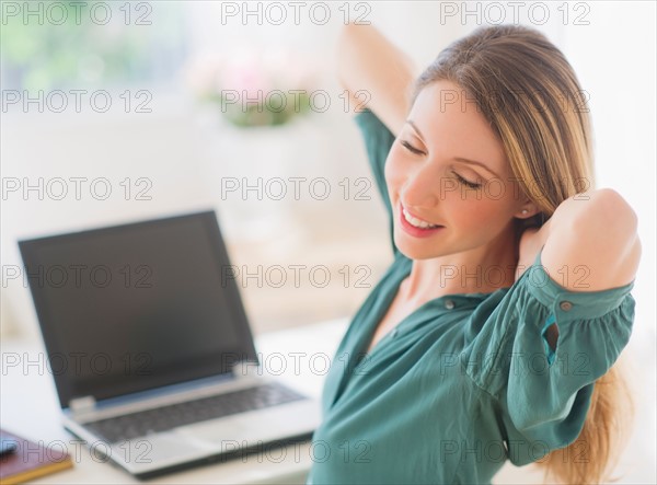 Portrait of young woman working with laptop. Photo : Daniel Grill