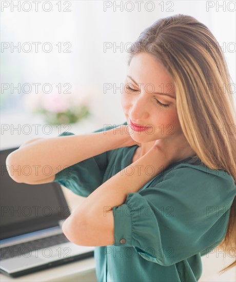 Portrait of young woman working with laptop. Photo : Daniel Grill