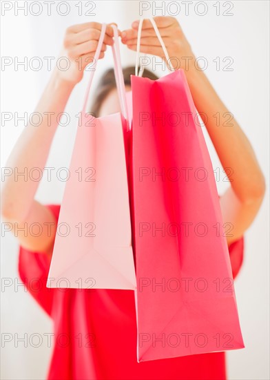 Portrait of young woman with shopping bags. Photo : Daniel Grill