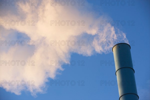 Low angle view of smoke stack. Photo : fotog