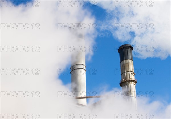 part of chimneys coverred by smoke. Photo : fotog