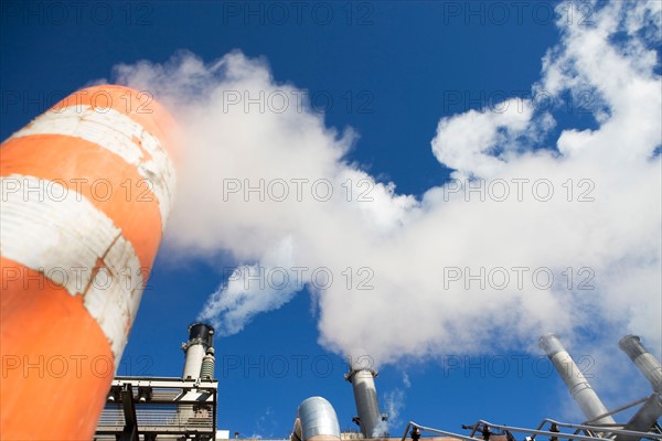 low angle view of factory chimneys. Photo : fotog