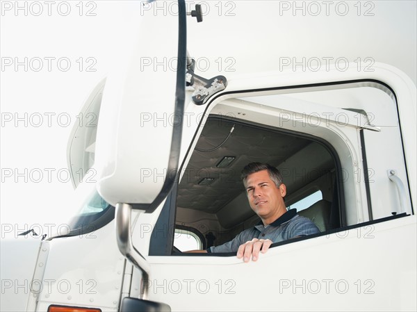 Truck driver entering truck.