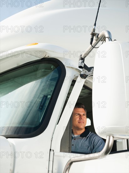 Truck driver sitting in truck.