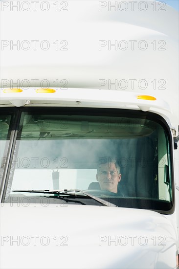 Truck driver sitting in truck.