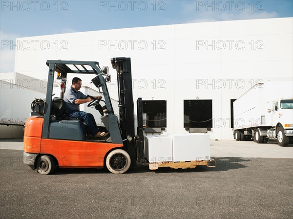 Man driving forklift.