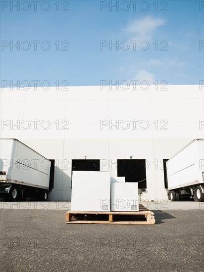 Warehouse with trucks and load.