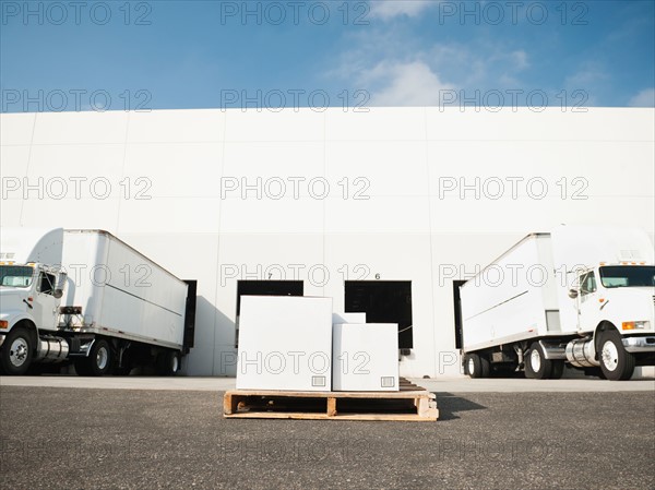 Warehouse with trucks and load.