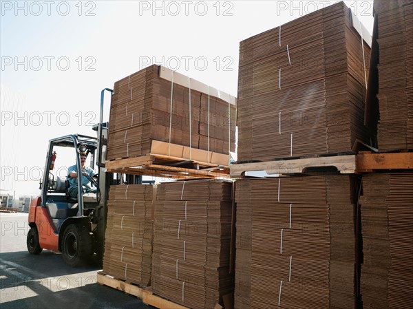 Forklift truck moving pallets.