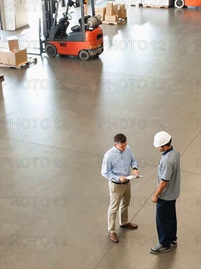 Workers talking in warehouse.