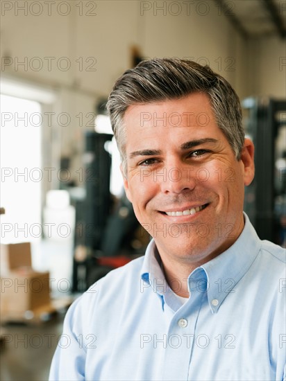 Portrait of businessman in warehouse.