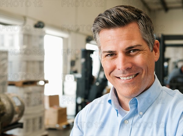 Portrait of businessman in warehouse.