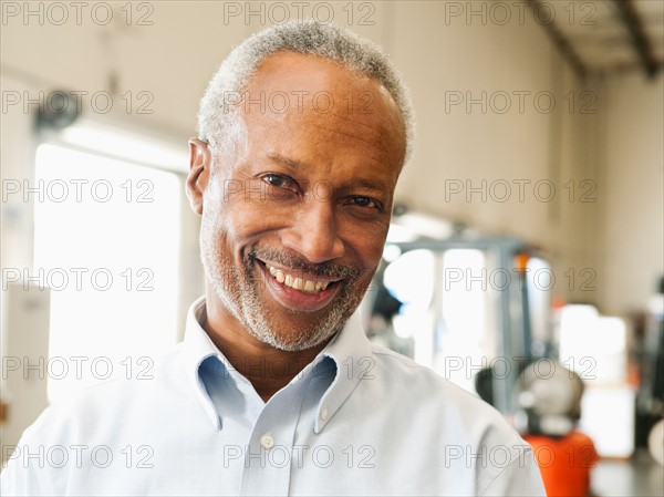 Portrait of businessman in warehouse.