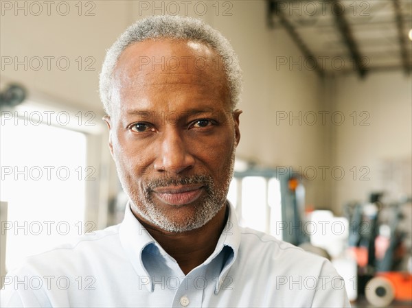Portrait of businessman in warehouse.