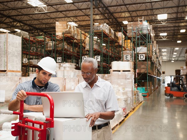 Men working in warehouse.