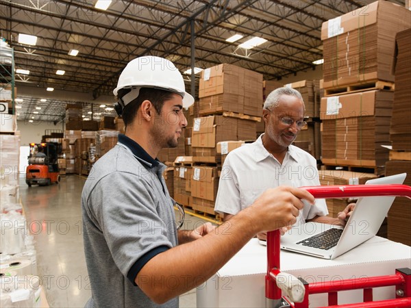 Men working in warehouse.