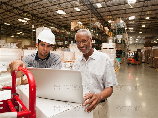 Men working in warehouse.