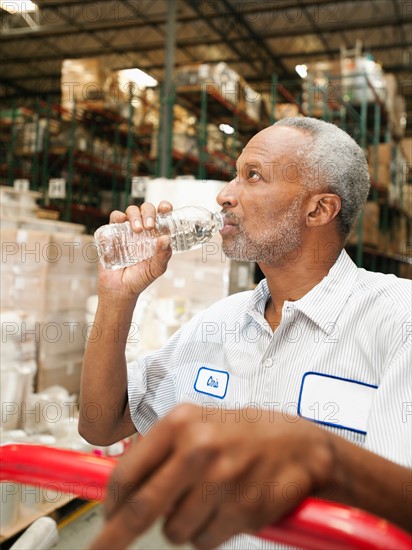 Warehouse worker drinking water.