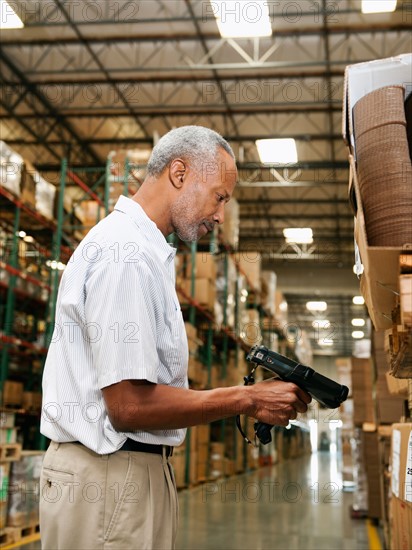 Warehouse worker scanning delivery.