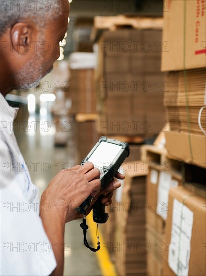 Warehouse worker scanning delivery.